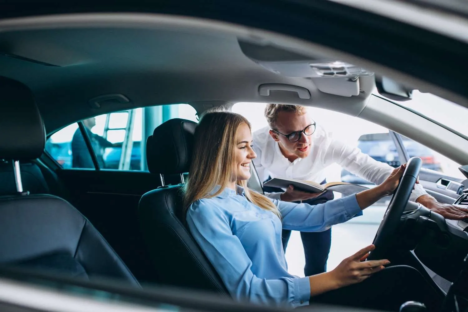 Driver seated in a car talking with an advisor